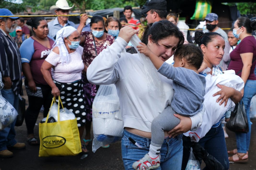 Family members deliver supply packages for relatives detained during the state of emergency in Izalco